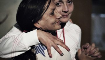 Woman hugging another woman