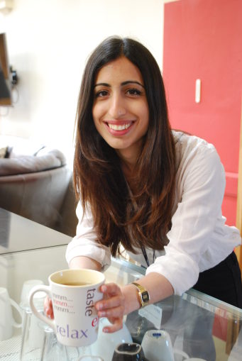 Woman smiling holding a mug