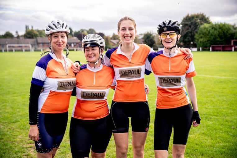 Group of cyclists wearing orange Depaul t-shirts