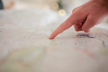 Finger pointing at a map