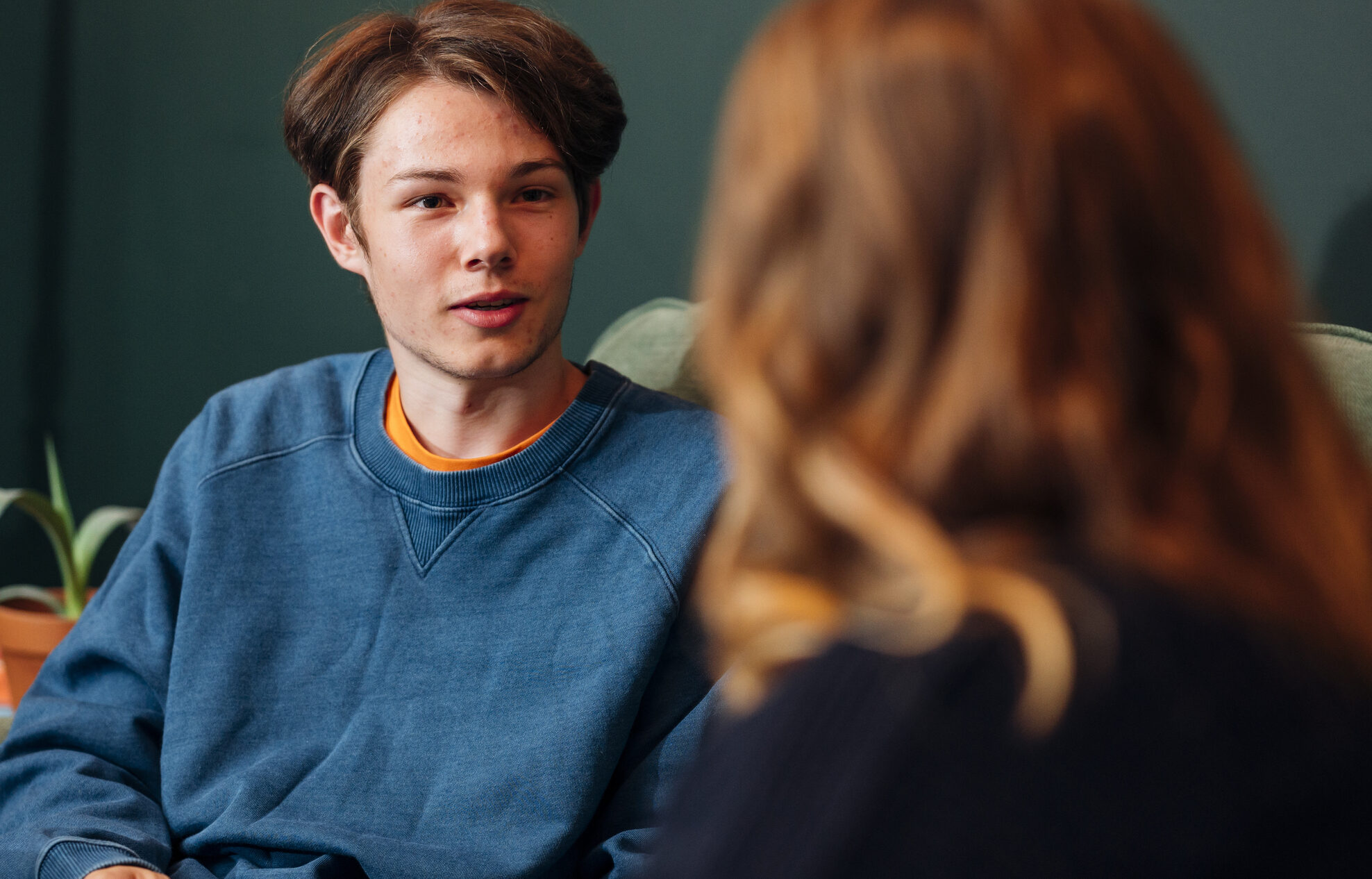 young person talking to Nightstop host on a sofa