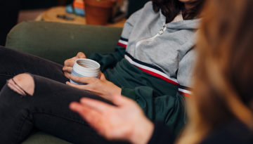 Close up of a young person holding of a cup of tea