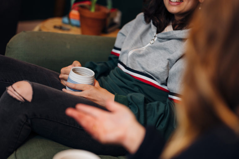 Close up of a young person holding of a cup of tea