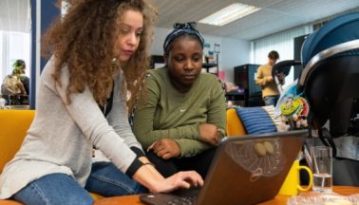 Woman and teenager looking at a laptop