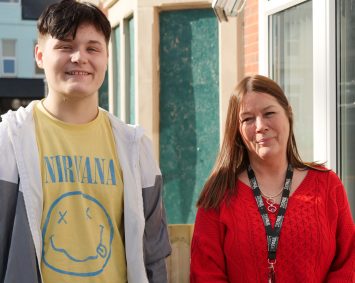 Depaul staff and young person standing outside a house smiling