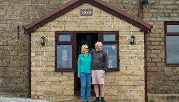 Cameron and Jane Baines outside their house