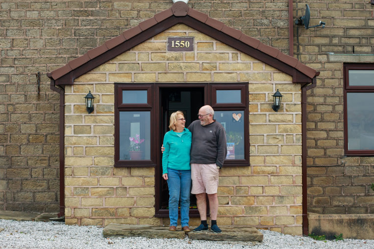 Cameron and Jane Baines outside their house