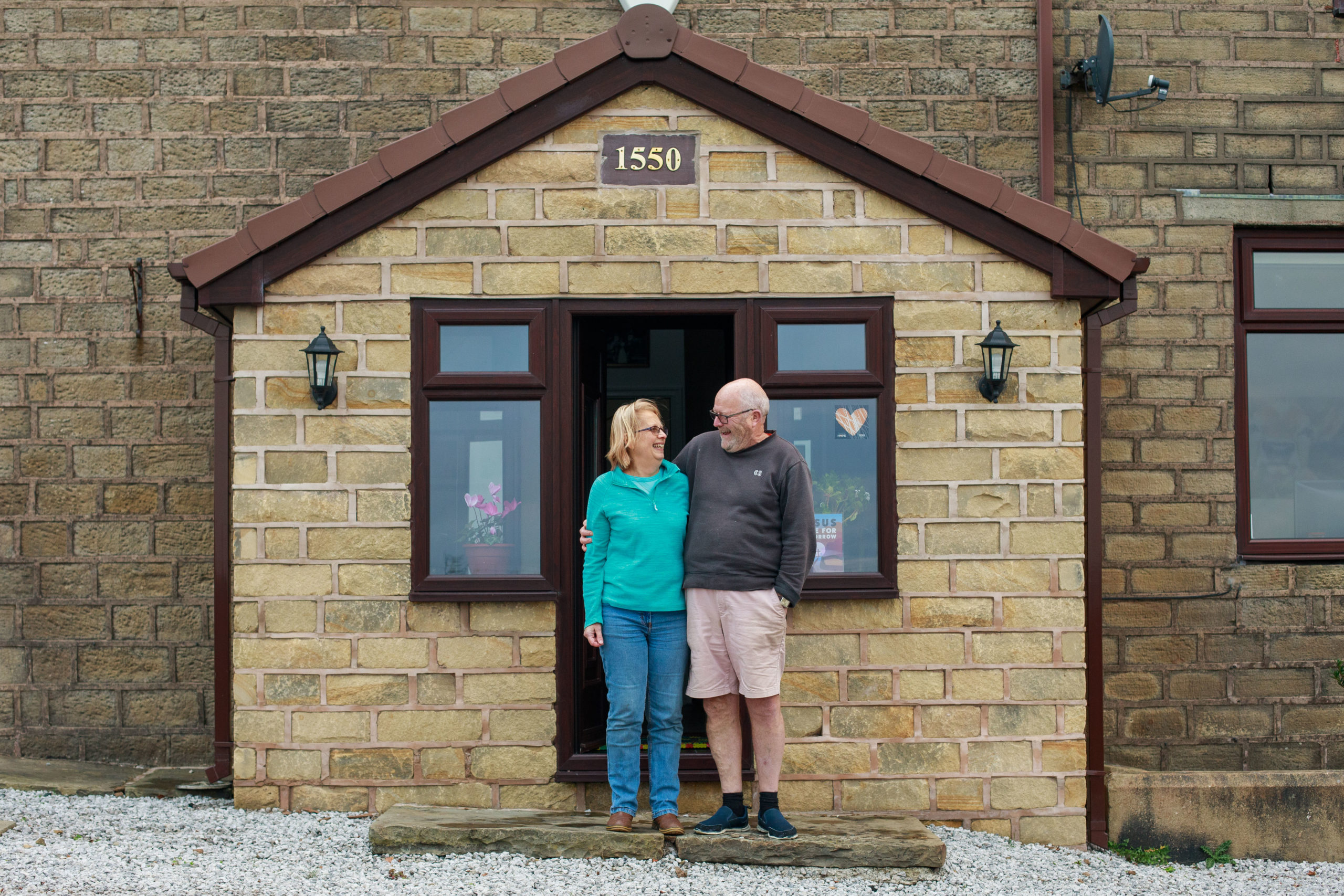 Cameron and Jane Baines outside their house