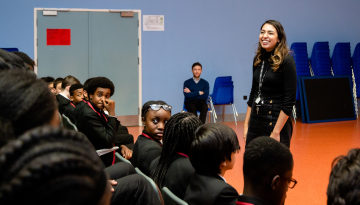 Depaul staff and pupils in a school hall