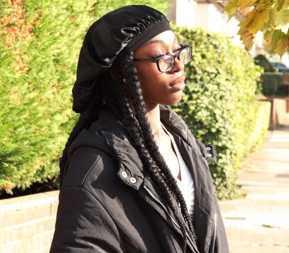 Young person standing in the street looking pensive