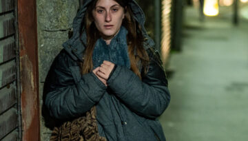 Jasmine standing on a dark street