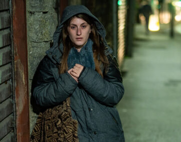 Jasmine standing on a dark street