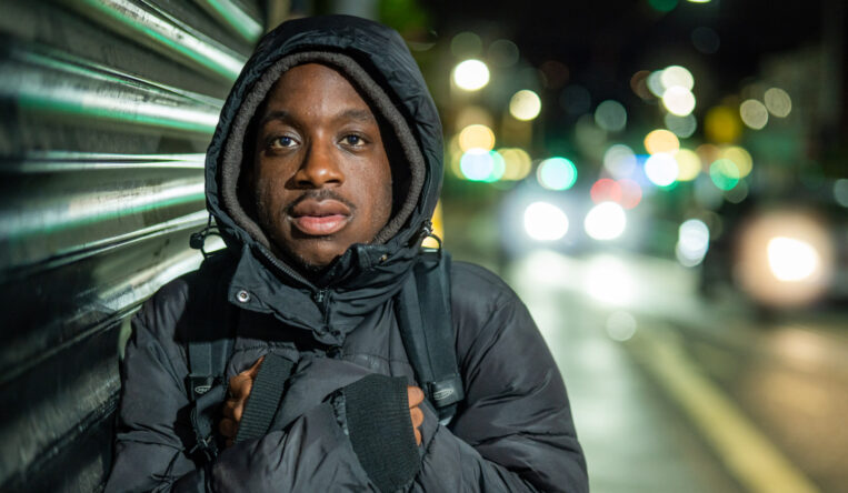 Gabriel standing on a dark street