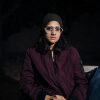 Young woman sat in the cold on a bench