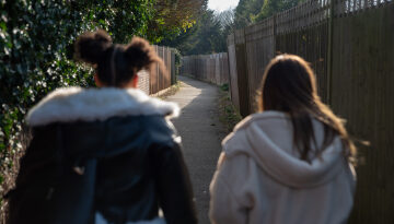 young people walking down a street together