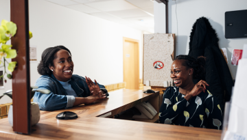 Young woman talking to Depaul UK staff