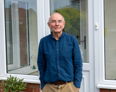 Mark Bryant standing outside his house
