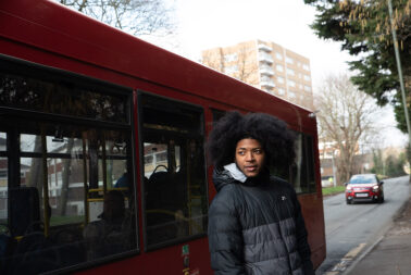 Man standing next to bus
