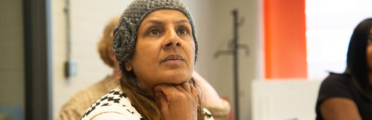 Image of woman listening to Depaul UK professionals training for teachers and other care givers