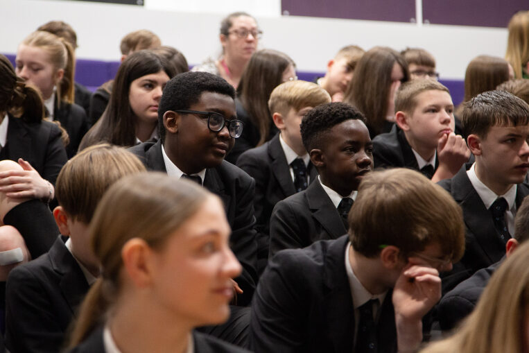 Teenagers in school assembly hall