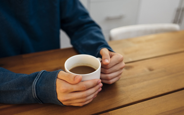 Man holding cup pf tea