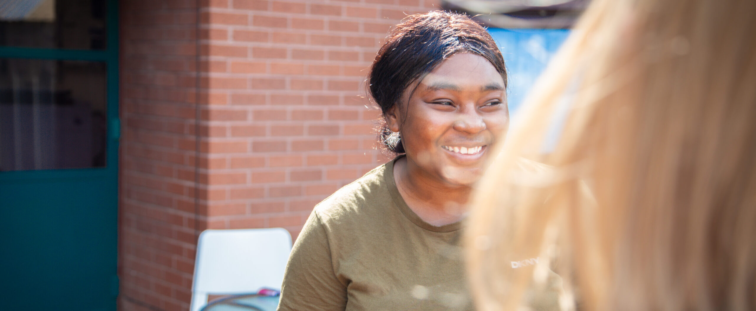 Young person smiling with the sun beaming on her face