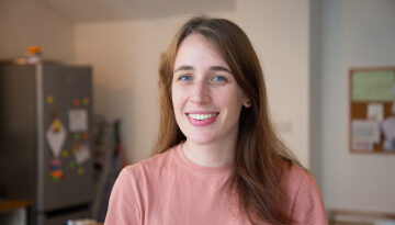 Nightstop host Becky smiling to camera stood in her kitchen