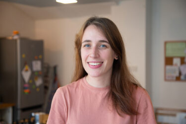 Nightstop host Becky smiling to camera stood in her kitchen
