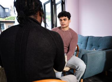 Young person Mo and Nightstop host sat at kitchen table