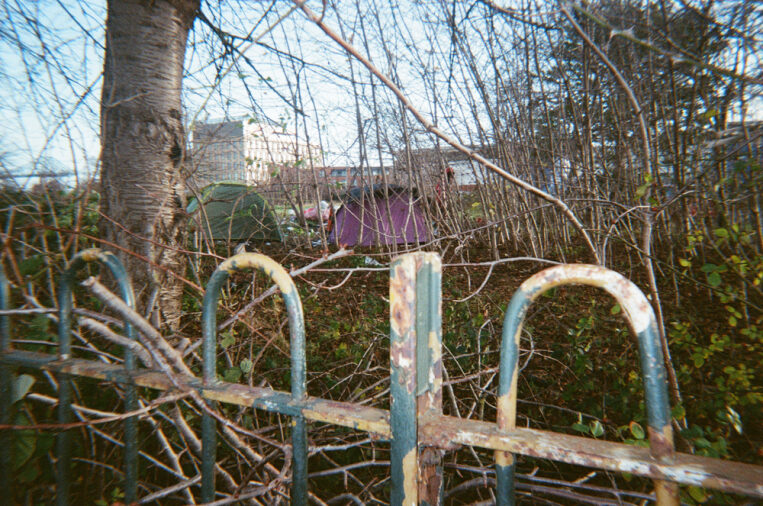 Image a of a tent behind a fence